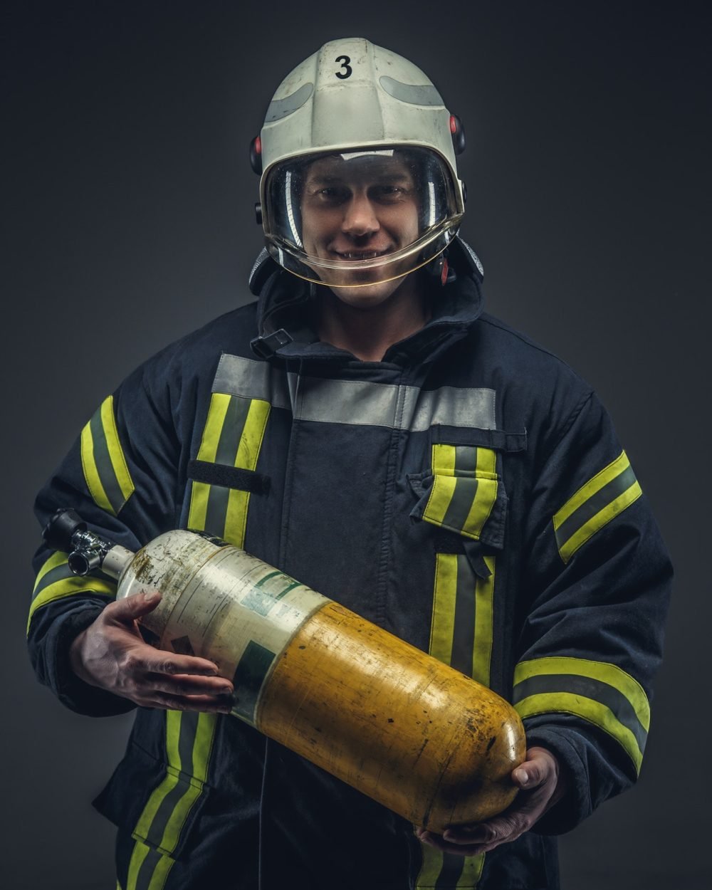 firefighter-rescue-holds-yellow-oxygen-tank-.jpg